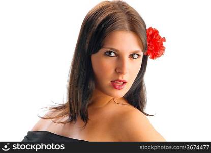 young spanish and cute girl with a black dress and a red carnation betweeen her hair