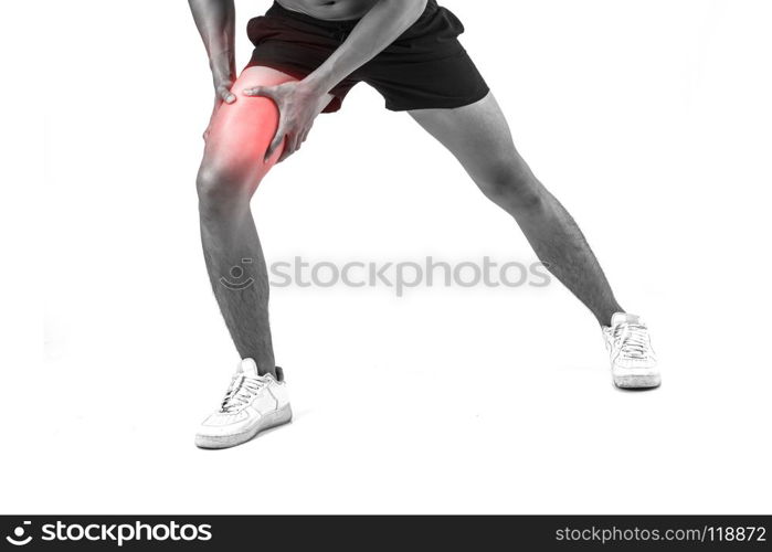 Young sport man with strong athletic legs holding knee with his hands in pain after suffering ligament injury isolated on white.. Young sport man with strong athletic legs holding knee with his