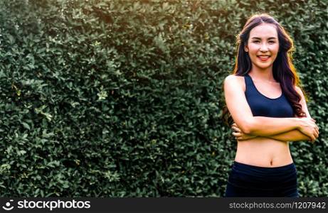 Young sport woman doing morning exercise in public park. Healthy lifestyle concept.. Young sport woman doing morning exercise in park.
