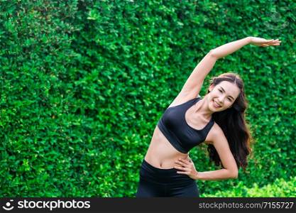 Young sport woman doing morning exercise in public park. Healthy lifestyle concept.