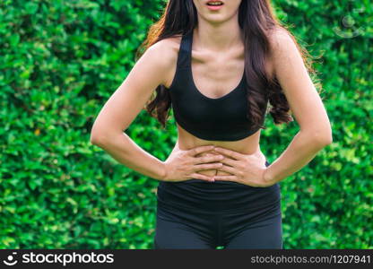 Young sport woman having pain at her stomach. Health problem concept.