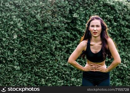 Young sport woman having pain at her stomach. Health problem concept.