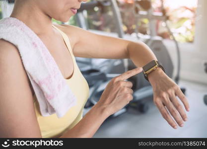 Young sport woman using smart watch in gym, Fitness, training lifestyle concept. Young sport woman using smart watch in gym