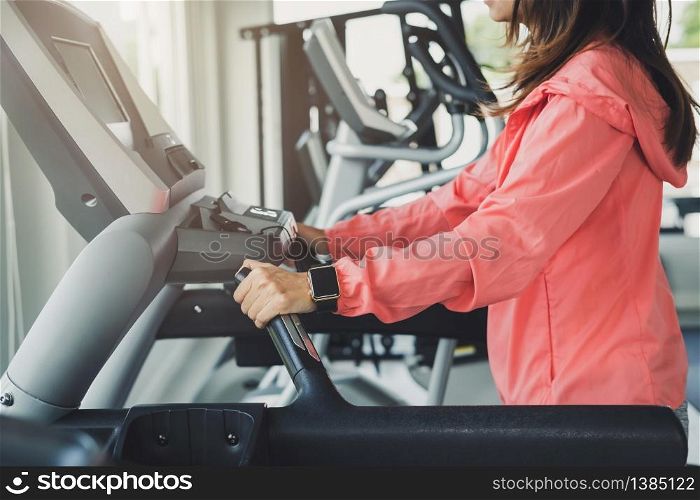 Young sport woman wearing smart watch running on treadmill at gym, Fitness, training lifestyle concept. Young sport woman wearing smart watch running on treadmill at gym