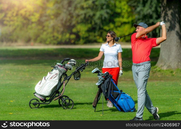 Young sportive couple on a golf course