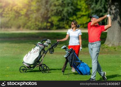 Young sportive couple on a golf course