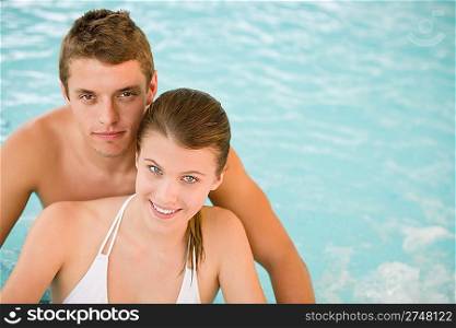 Young sportive couple relax in pool in luxury spa