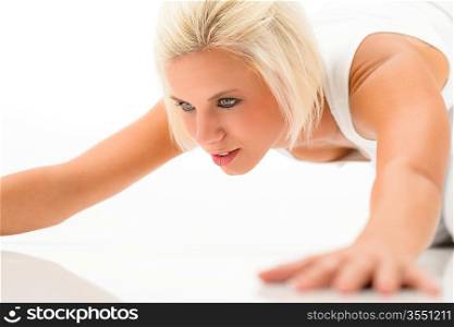 Young sportive woman doing push-ups on white background fitness exercise