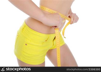 Young sports woman measuring waist. Isolated on white background