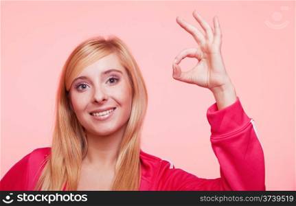 young sporty fitness woman happy smiling girl showing ok sign hand gesture on pink background