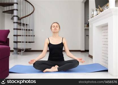 young sporty girl playing sports at home on yoga mat. Active Lifestyle. Doing Fitness At Home. Holiday Leisure. Body Balance. Sport Exercise. Triceps Exercises Training. quarantine sports