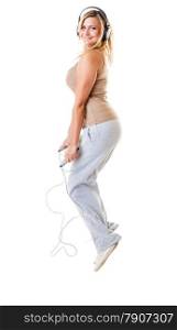young sporty girl plus size doing exercise with jump rope while listening music. Weight loss concept. Fitness woman isolated on white