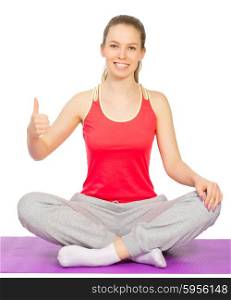 Young sporty girl sits is lotus pose isolated
