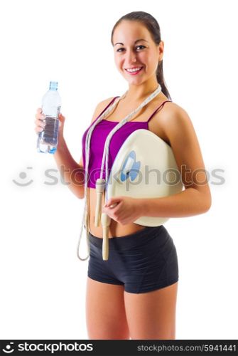 Young sporty girl with water bottle and scales isolated
