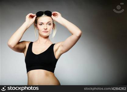 young sporty woman after workout on gray background.