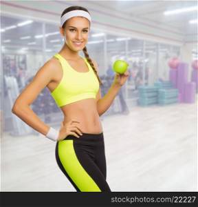 Young sporty woman in fitness club