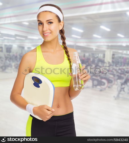 Young sporty woman in fitness club