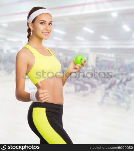 Young sporty woman in fitness club