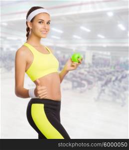 Young sporty woman in fitness club