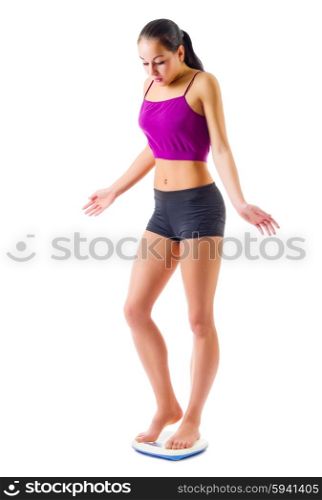 Young sporty woman on scales isolated