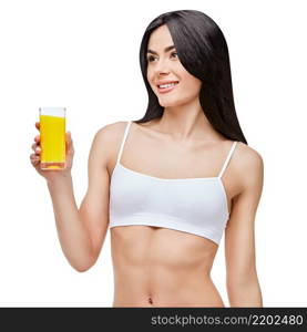 young sporty woman over gray background holding glass of orange juice. sporty woman over gray background holding glass of orange juice