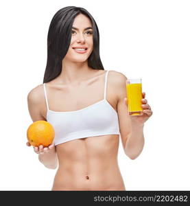 young sporty woman over gray background holding glass of orange juice. sporty woman over gray background holding glass of orange juice