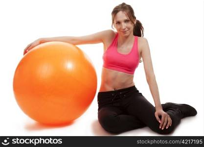 young sporty woman with a fitness ball. young sporty woman with a fitness ball on white background