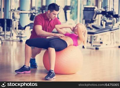 young sporty woman with trainer exercise in fitness gym