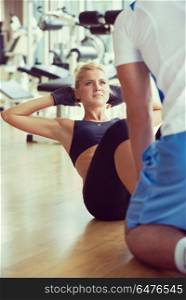 young sporty woman with trainer exercise in fitness gym