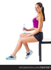 Young sporty woman with water bottle sit on the bench isolated