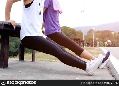 Young sporty woman workout before fitness training warming up in outdoors