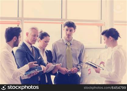 young startup businessman making presentation of project to senior investior, group of business people taking notes and make plans on white flip board and tablet computer