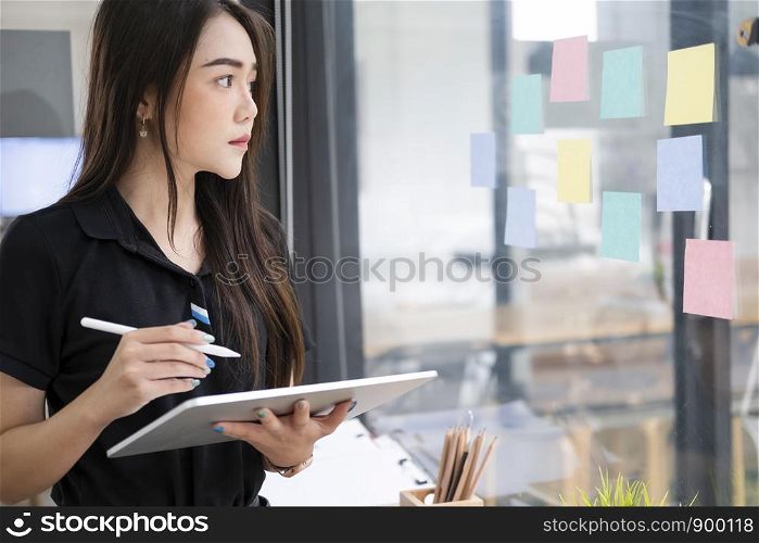 Young startup businesswoman using tablet searching infomation marketing data online.