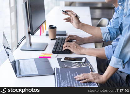 Young startup Programmers Sitting At Desks Working On Computers screen for Developing programming and coding to find solution to problem on New Application