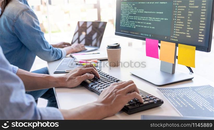 Young startup Programmers Sitting At Desks Working On Computers screen for Developing programming and coding to find solution to problem on New Application