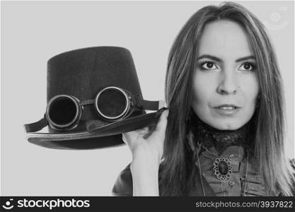 Young steampunk girl holding fancy hat. Fantasy old fashion with topper and goggle.