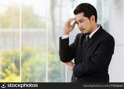 young stressed business man thinking about problem in office