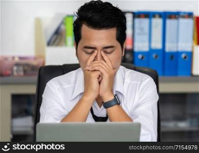 young stressed business man using laptop and working problem