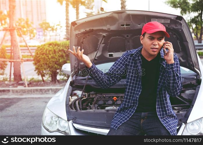 young stressed man having trouble with his Stress broken car Engine room crash at failed engine Wait for help.