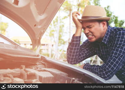 young stressed man having trouble with his Stress broken car Engine room crash at failed engine Wait for help.