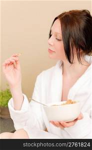 Young student attractive girl eat cereal for breakfast wear bathrobe