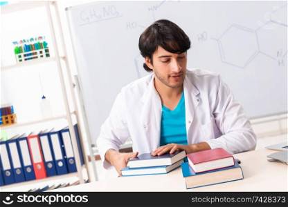 Young student chemist in the classroom 
