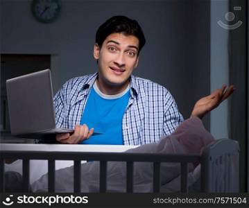 Young student doing homework and looking after newborn baby. The young student doing homework and looking after newborn baby