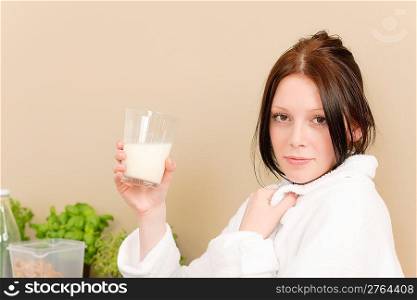Young student girl drink glass of milk for breakfast