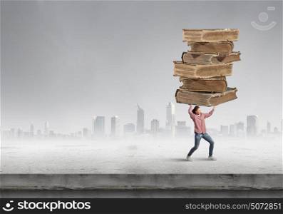 Young student girl lifting pile of old books above head. Master science