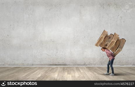 Young student girl lifting pile of old books on back. Master science