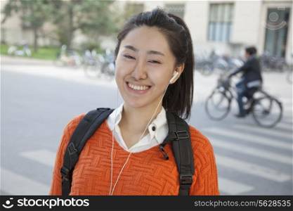 Young student listening to music, portrait
