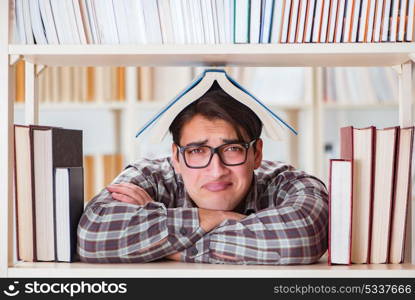 Young student looking for books in college library