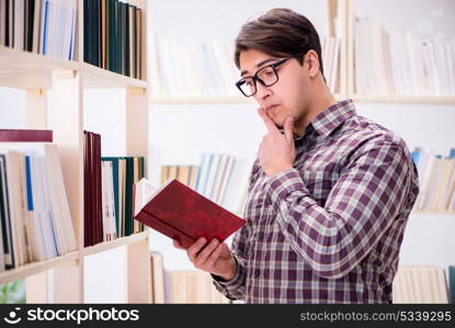 Young student looking for books in college library