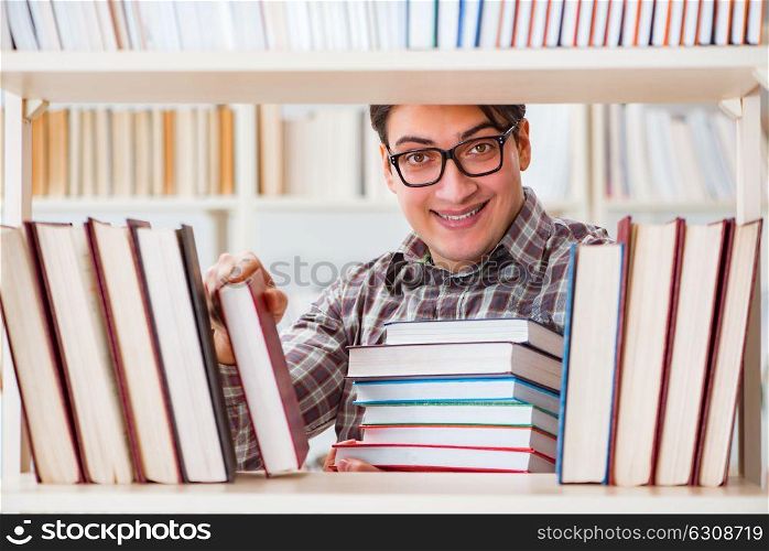Young student looking for books in college library